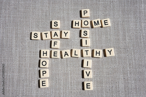 Tableau sur toile Word game with crossword grids showing various words - stay, home, hope, healthy, safe, and positive - isolated on gray cotton background