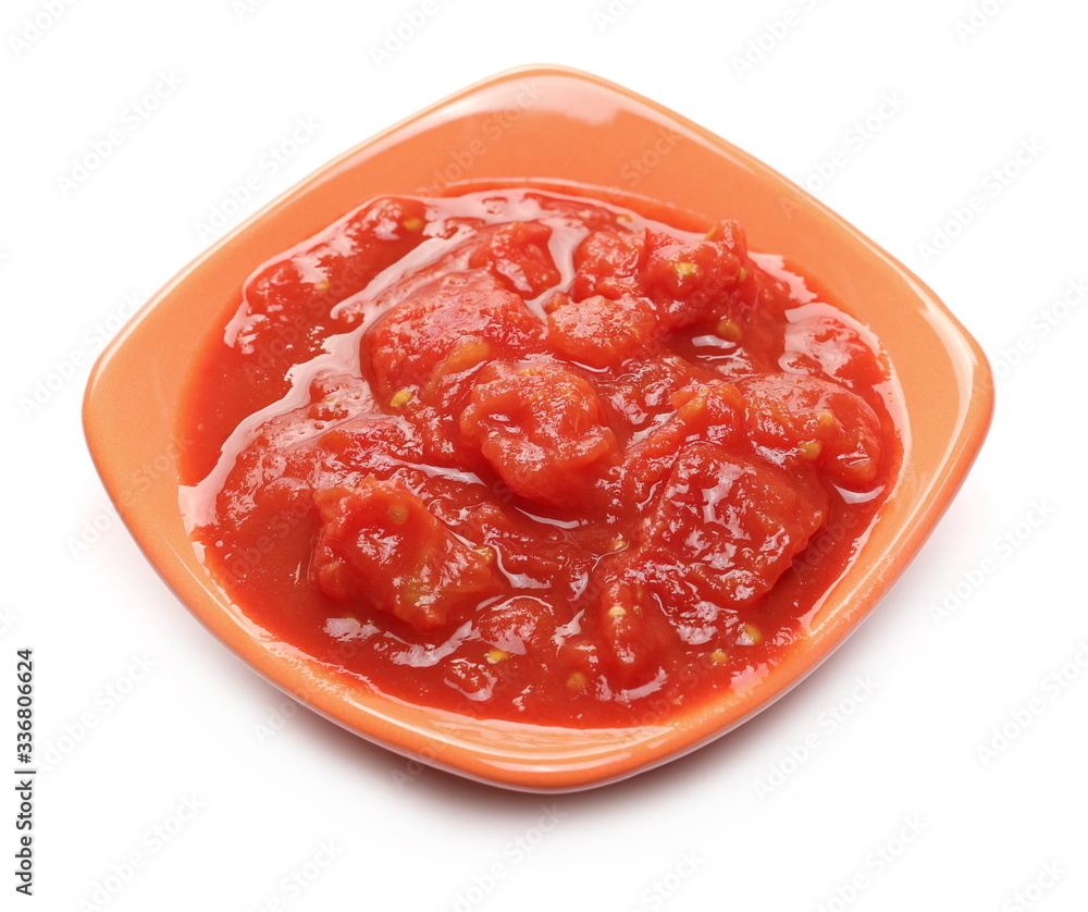 Tomato cubes, pieces organic pure texture in ceramic bowl, isolated on white background Tomato cubes, pieces organic pure texture in ceramic bowl, isolated on white background