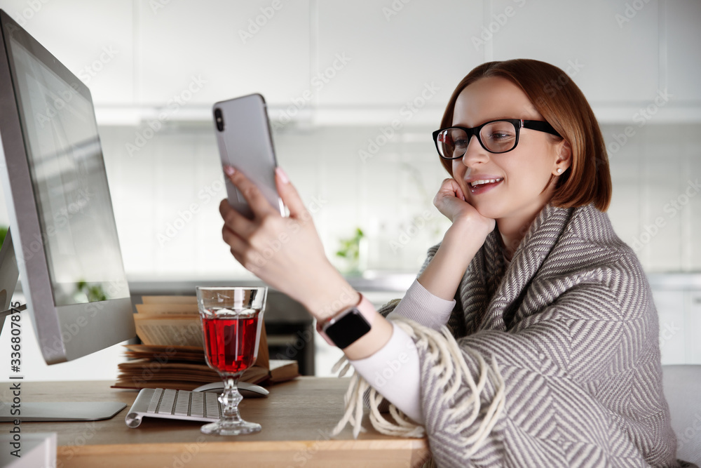 Woman at home in self isolation due to coronavirus covid-19 quarantine, using technology for online communication while social distancing. Entertainment indoors, connection with friends and family. Woman at home in self isolation due to coronavirus covid-19 quarantine, using technology for online communication while social distancing. Entertainment indoors, connection with friends and family.