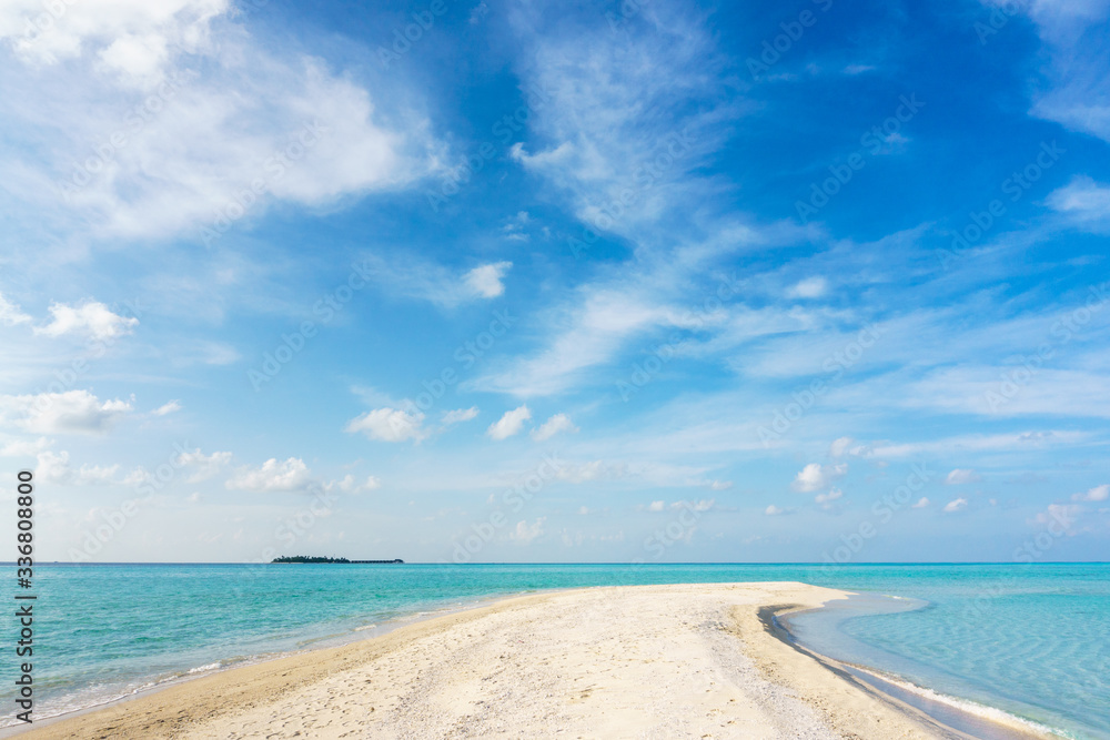 View of the beach of an unnamed coral island. Maldives.