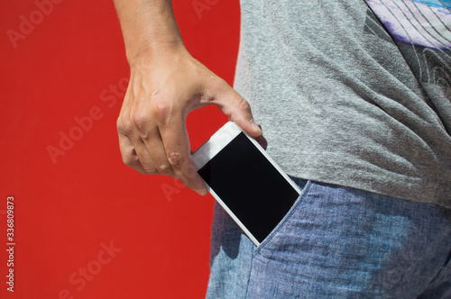 A mobile cell phone in pocket, closeup.