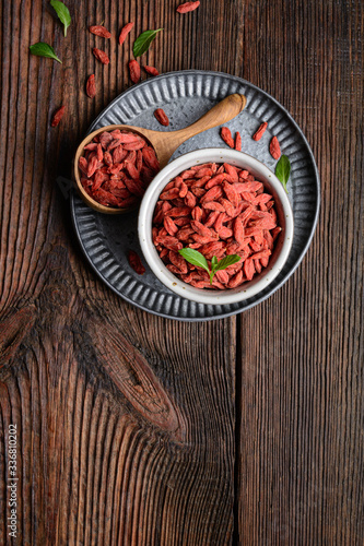 Healthy snack rich in antioxidants and vitamins for boosting immunity, dried Goji berry in a bowl and scoop with copy space