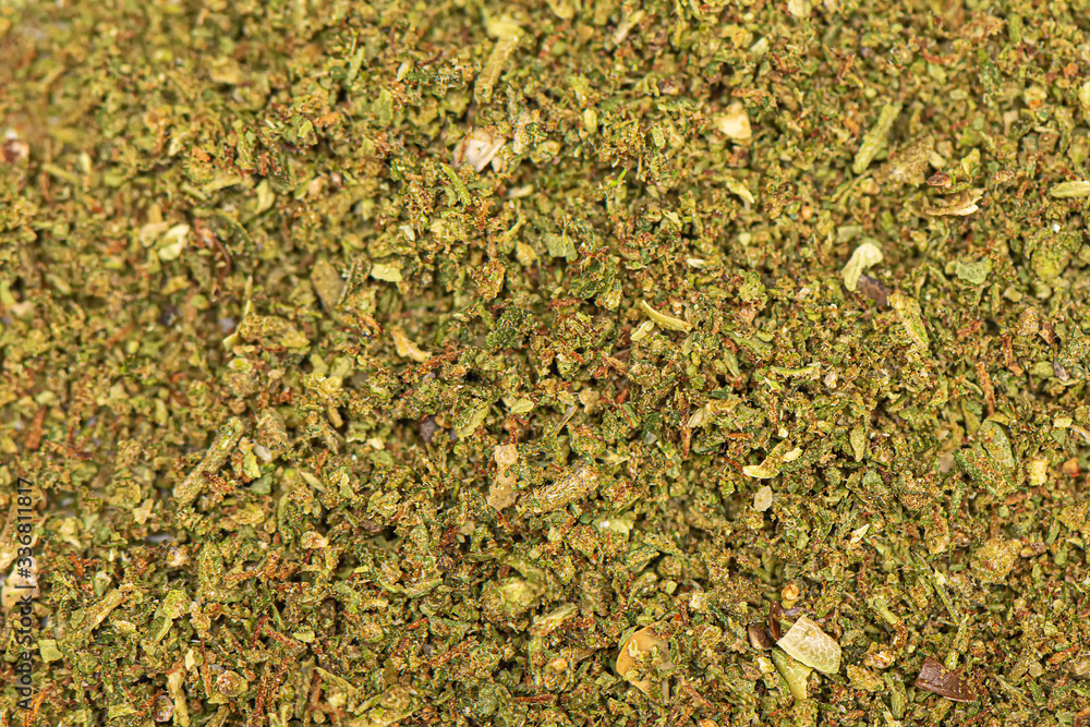 Perfectly grinded green dried marijuana background. Cannabis texture. Close up of marijauna pattern. Perfectly grinded green dried marijuana background. Cannabis texture. Close up of marijauna pattern.