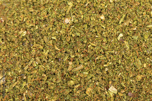 Perfectly grinded green dried marijuana background. Cannabis texture. Close up of marijauna pattern.