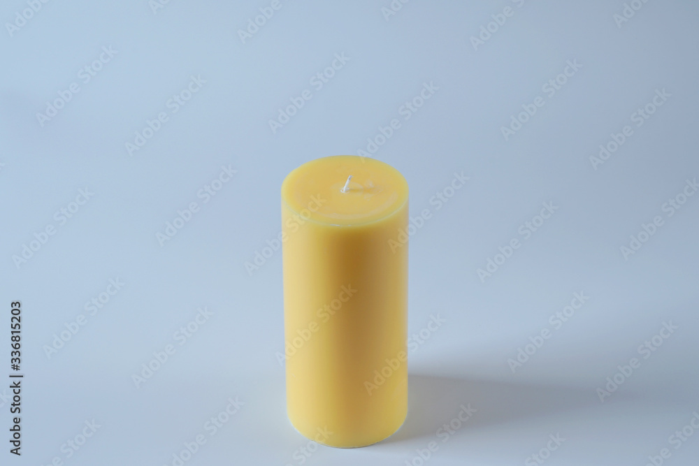 Tall yellow wax candle on white. Tall yellow wax candle on white.