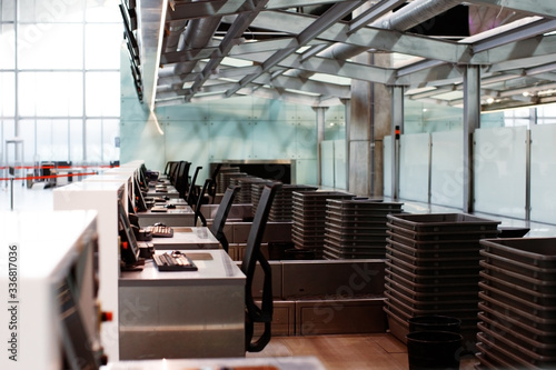 Empty check-in desks in airport, in coronavirus quarantine isolation, tourism industry crisis, airlines bankrupt, pandemic infection worldwide spread, travel restrictions and border shutdown