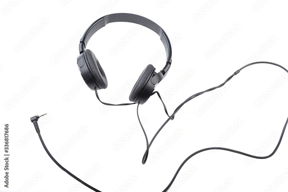 Black wired headphones on a white background. Black wired headphones on a white background.