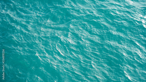 Pure turquoise smooth water surface aerial view
