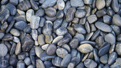 Texture of sea pebbles. gray-blue sea pebbles structure. smooth oval ocean stones. decor concept