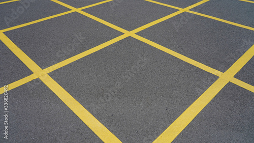  Asphalt in yellow diagonal stripes. road marking. dark gray asphalt in yellow rhombs.