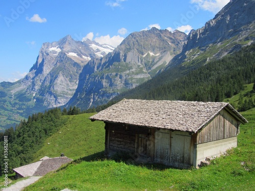 Mountainside cabins rest in a quiet region of the Swiss Alps just outside Grindelwald Switzerland.