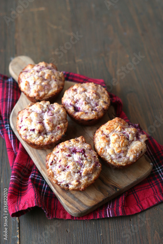 Fresh and warm homemade muffins on red tableclothe