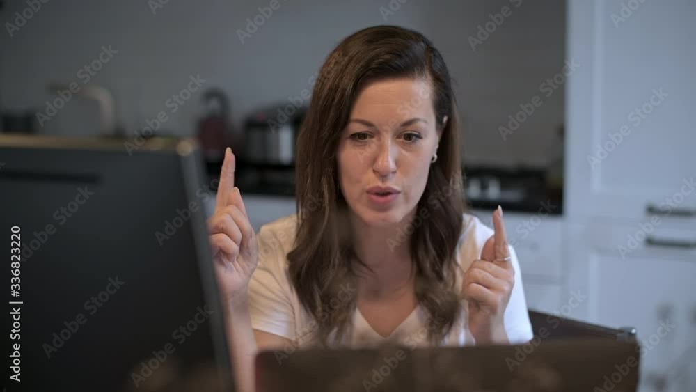 A young, beautiful woman is looking at a computer monitor. Remote work. Online teaching. The teacher shows the exercise. The neuropsychologist works remotely. Home furnishings. A young, beautiful woman is looking at a computer monitor. Remote work. Online teaching. The teacher shows the exercise. The neuropsychologist works remotely. Home furnishings.