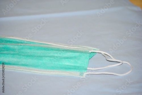 Two surgical masks on blue textile background