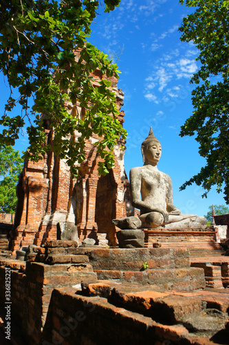 Meditating Serene Buddha in front of Prang