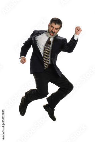 Mature hispanic businessman jumping of joy