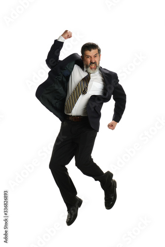 Mature hispanic businessman jumping of joy