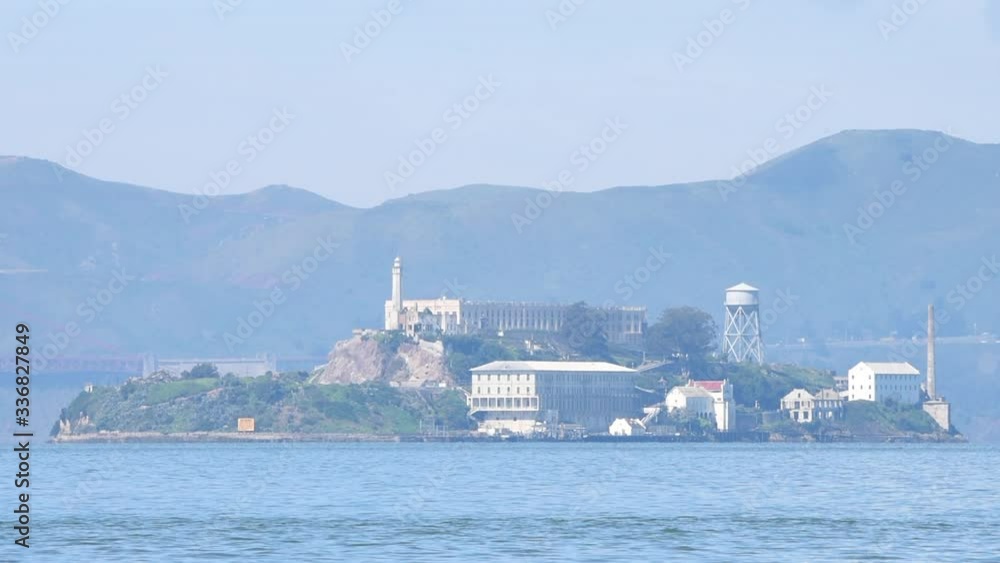 HD video zooming in on Alcatraz Island, 1.25 miles away from San Francisco on a hazy day. The islands facilities are managed by the National Park Service and it is open to the public for tours.