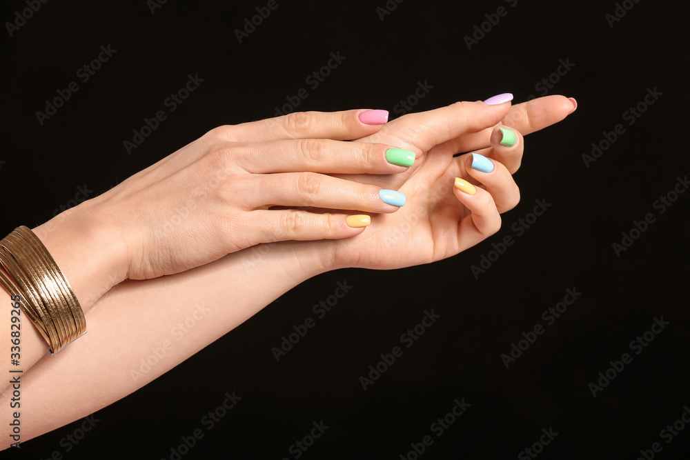 Hands of young woman with beautiful manicure on dark background Hands of young woman with beautiful manicure on dark background
