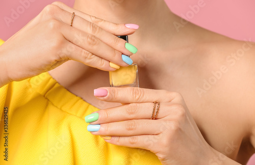 Young woman with beautiful manicure and nail polish on color background  closeup