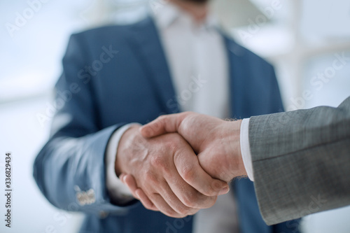business partners greet each other standing in the office photo