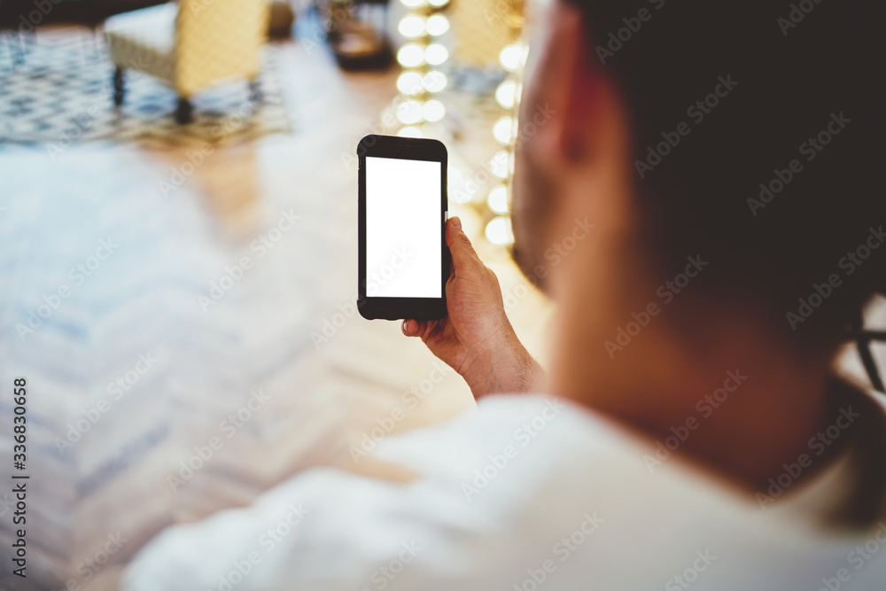 Man surfing on cellphone in room Man surfing on cellphone in room