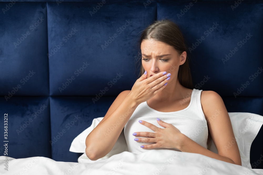Woman Coughing And Touching Chest Feeling Bad Sitting In Bed Woman Coughing And Touching Chest Feeling Bad Sitting In Bed