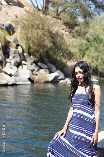 Spectacular middle eastern young woman is posing on the Nile 