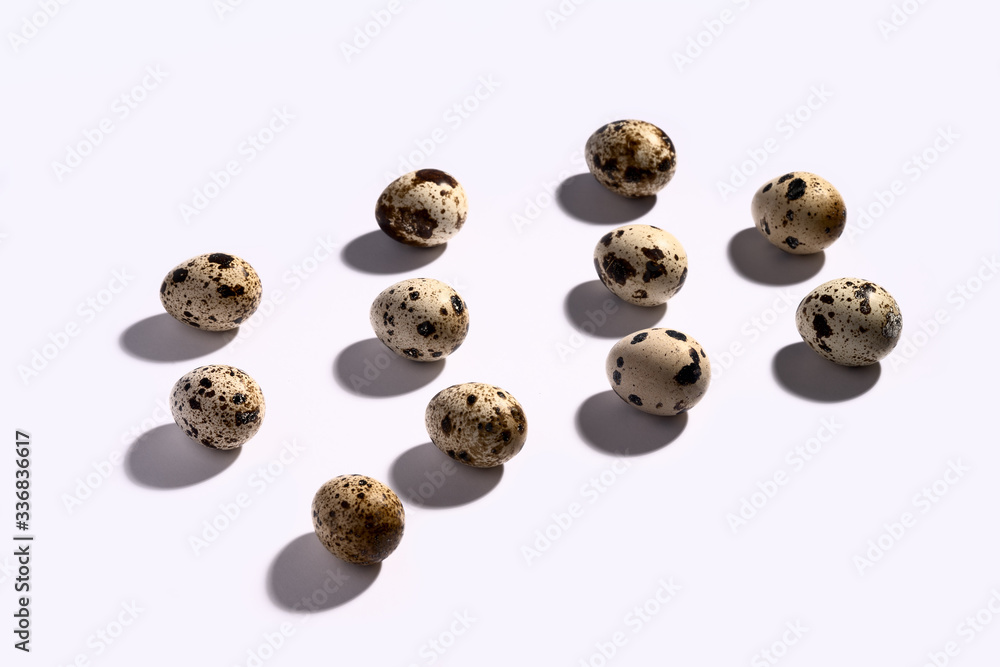 Creative quail egg layout on white background. Quail eggs pattern. Happy easter concept. Minimal design. Copy space, flat lay, from above Creative quail egg layout on white background. Quail eggs pattern. Happy easter concept. Minimal design. Copy space, flat lay, from above