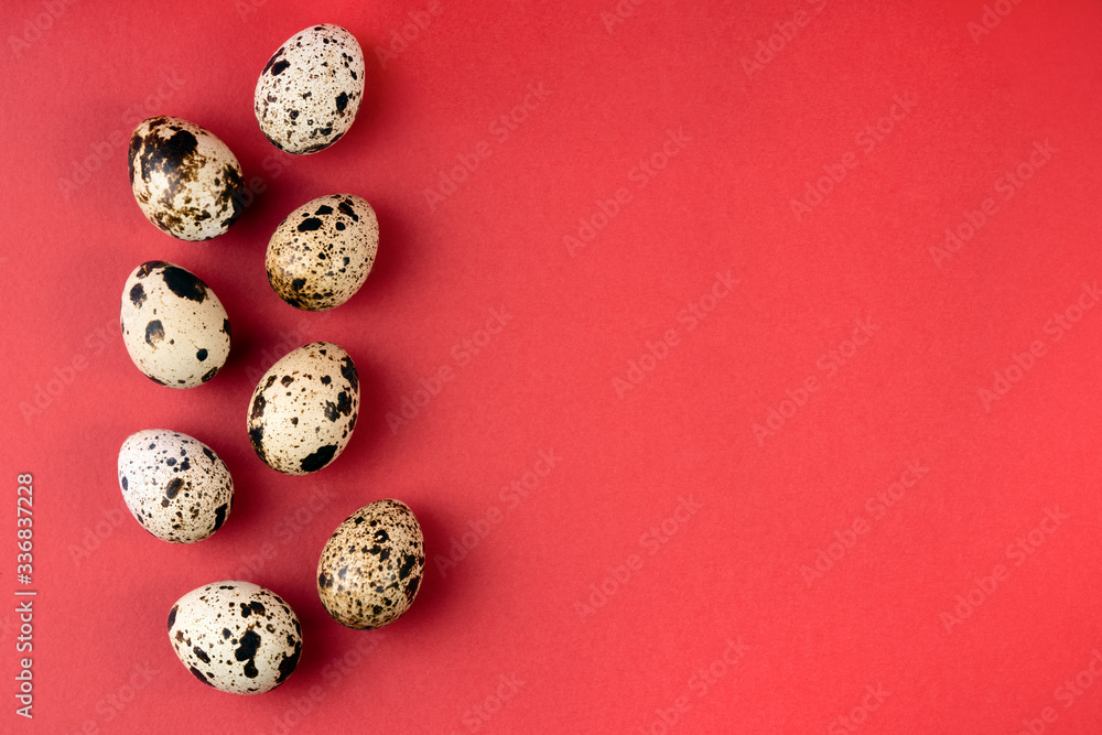Creative quail egg layout on red background. Happy easter concept. Minimal design. Copy space, flat lay, from above Creative quail egg layout on red background. Happy easter concept. Minimal design. Copy space, flat lay, from above