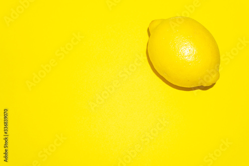 Lemon isolated on yellow background.