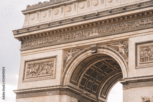 Architectural fragment of Arc de Triomphe. Arc de Triomphe de l'Etoile on Charles de Gaulle Place is one of the most famous monuments in Paris.