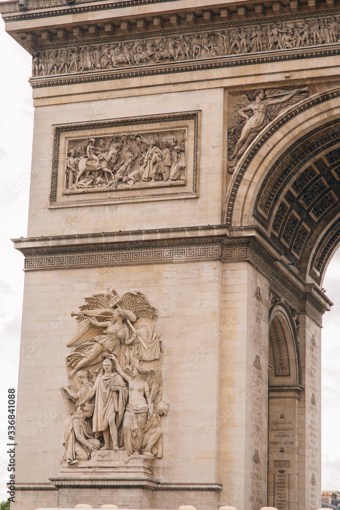 Architectural fragment of Arc de Triomphe. Arc de Triomphe de l'Etoile on Charles de Gaulle Place is one of the most famous monuments in Paris.