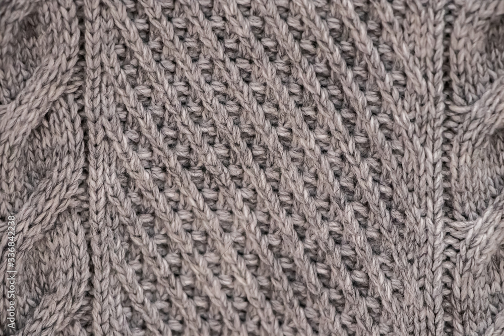 The texture of a knitted sweater. Knitting, home accessories. The texture of a knitted sweater. Knitting, home accessories.