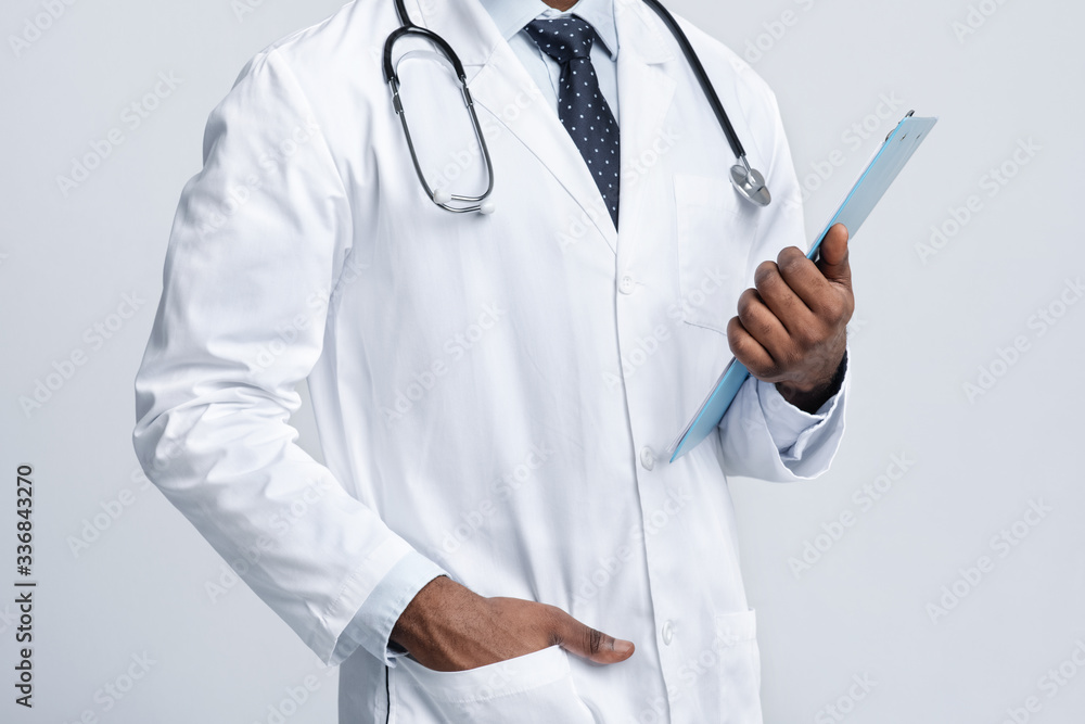 Cropped of black therapist holding medical chart Cropped of black therapist holding medical chart