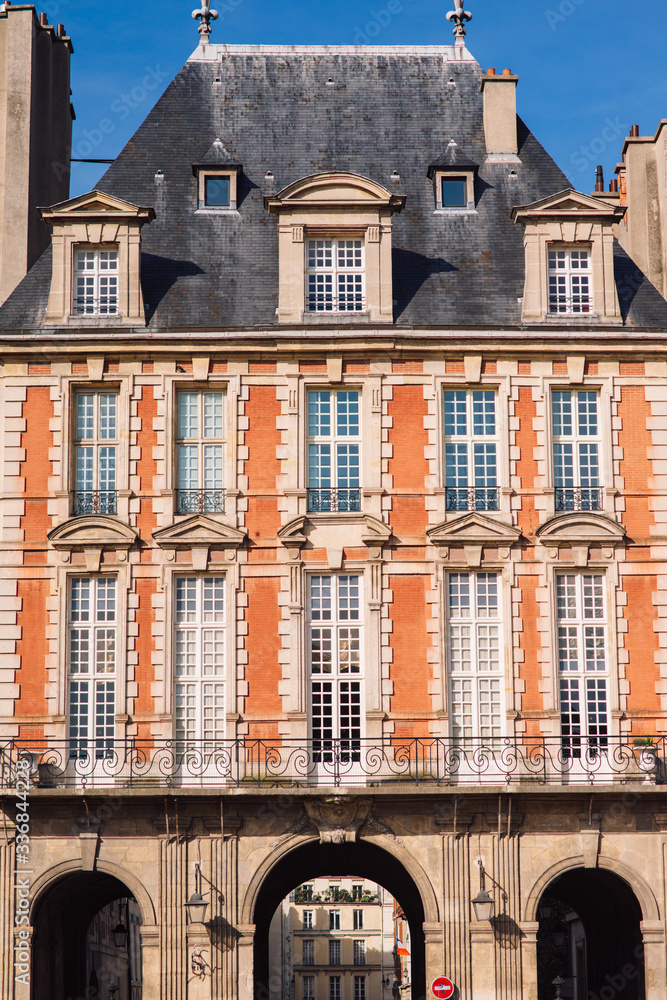 Fototapeta premium Typical building at Place des Vosges known as Place Royale - oldest planned square in Paris, in Marais district. Place des Vosges built by Henri IV from 1605 to 1612. Paris