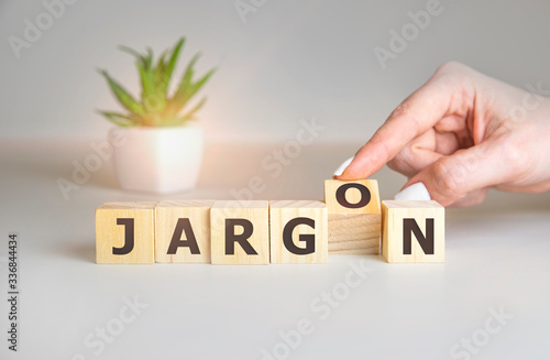Jargon - hand holding word from wooden blocks with letters, special words and phrases jargon concept, top view on white background.