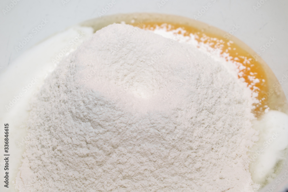 The process of making dough. Flour and eggs in a bowl. Homemade food concept. The process of making dough. Flour and eggs in a bowl. Homemade food concept.