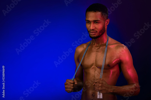Athletic Black Man Holding Jumping Rope Posing On Blue Background
