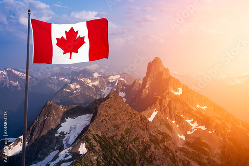 Canadian National Flag Composite over the Aerial View of Beautiful Rocky Mountain Landscape during sunny Sunset. Taken in Remote Area near Vancouver, British Columbia, Canada.
