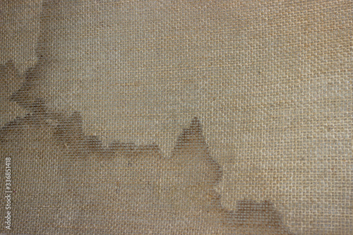 Loose fabric on the underside of the carpet.