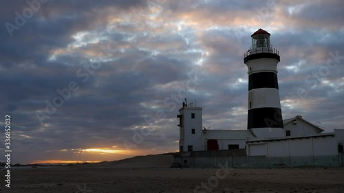Cape Recife Lighthouse at sunset on dramatic cloudy sky evening in Port Elizabeth. Time lapse