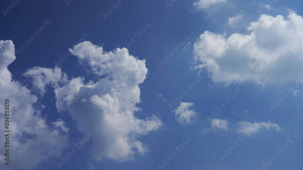 blue sky with white clouds and bright sun. dramatic summer sky background blue sky with white clouds and bright sun. dramatic summer sky background