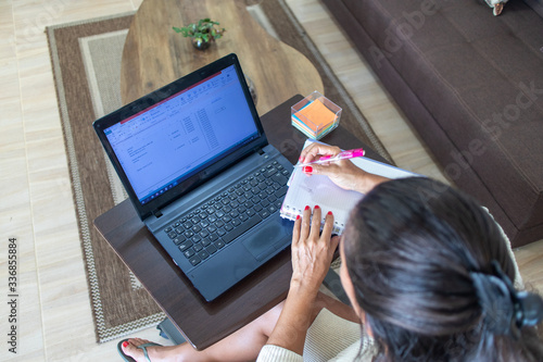 top view of a women working from home, social distancing. Top view of woman using laptop at the living room 