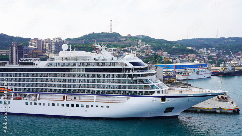 White large beautiful cruise ship moored in an Asian port. luxury liner in the passenger port for boarding passengers. travels in the pacific ocean