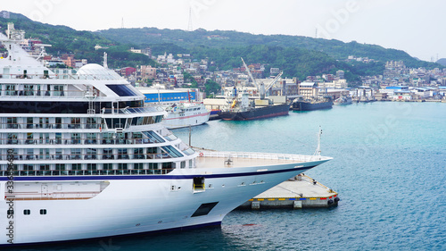 White large beautiful cruise ship moored in an Asian port. luxury liner in the passenger port for boarding passengers. travels in the pacific ocean © Artem