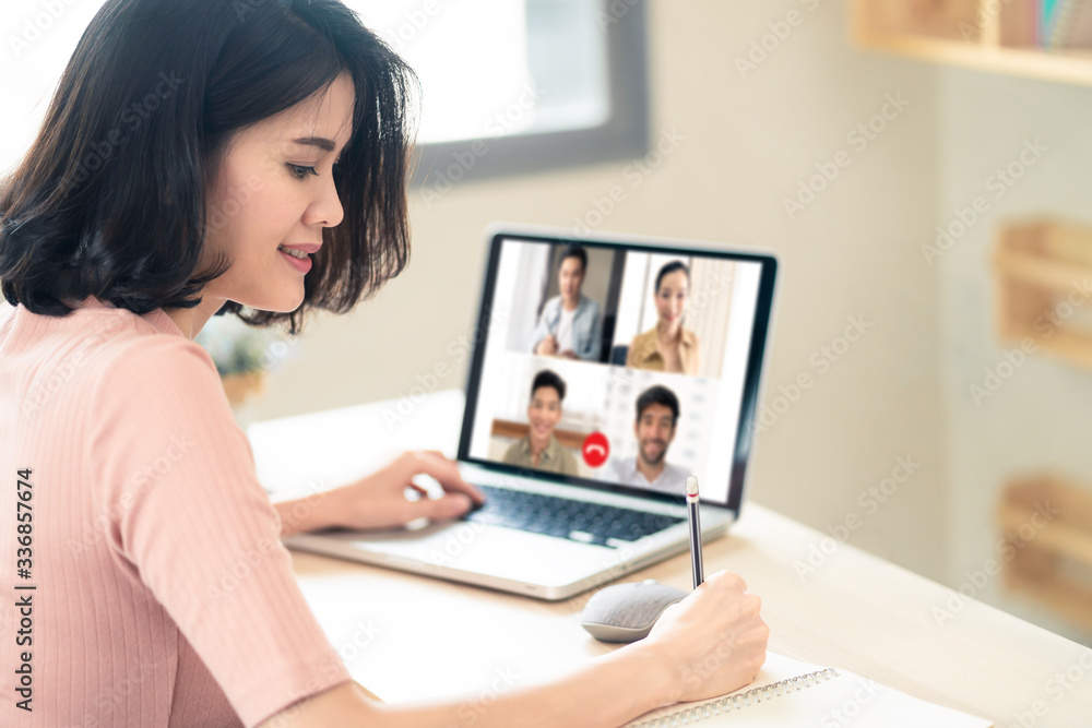 Asian business woman talking to colleague team about plan in video conference. Group of multiethnic business people using computer for online meeting in video call conference. Smart working from home. Asian business woman talking to colleague team about plan in video conference. Group of multiethnic business people using computer for online meeting in video call conference. Smart working from home.