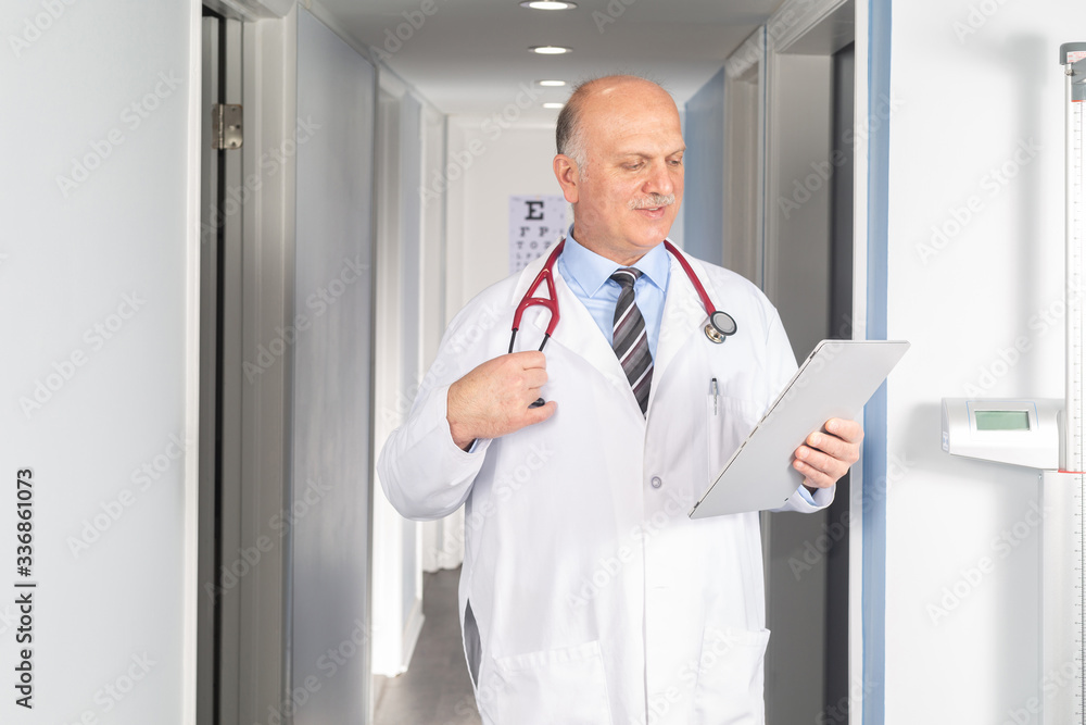 Doctor holding digital tablet at his office Doctor holding digital tablet at his office