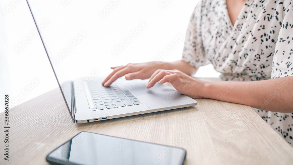 Close up low angle view of Woman in quarantine for Coronavirus wearing protective mask and smart working Hands holding credit card and using laptop. Online shopping Close up low angle view of Woman in quarantine for Coronavirus wearing protective mask and smart working Hands holding credit card and using laptop. Online shopping