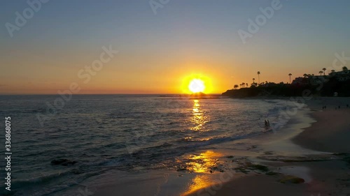 Low aerial video shot of a beach at Sunset filmed in cinema 4k